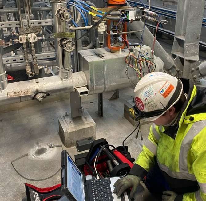 Empower Solutions technician running control valve diagnostics on a laptop at a process plant