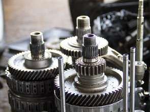 Stripped industrial gearbox internals with gear train exposed for inspection
