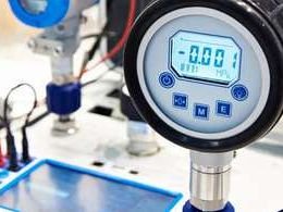 Digital pressure gauge under calibration on a laboratory test bench